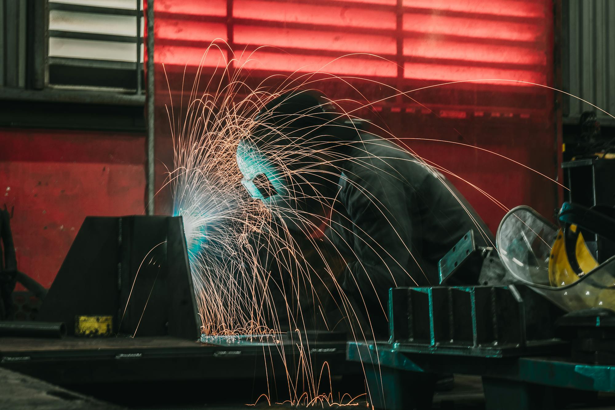 Industrial welder at work — arc light and sparks